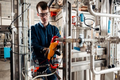 C-Capture’s Process Engineer, John Mackay with a carbon capture solvent compatibility unit.